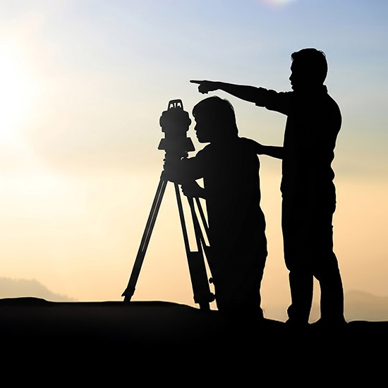 Meet-the-Leadership-feature - Man Helping another man do some surveying at twilight